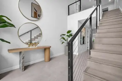 a hallway with a round mirror and a wooden bench at Casa Amoret - Brand New Family-Friendly Retreat in Miami