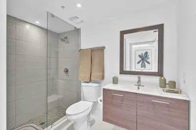 a bathroom with a toilet and a shower and a sink at Waterfront Luxury Kosher Condo with Rooftop Pool, Bay Harbor Islands in Miami Beach