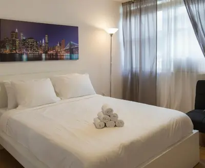 two teddy bears sitting on a white bed at 713 Miami Beach Apartments in Miami Beach