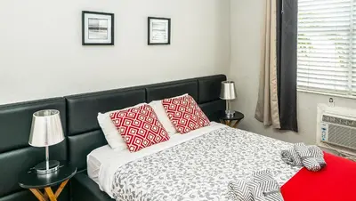 a bedroom with a bed with red and white pillows at 713 Miami Beach Apartments in Miami Beach