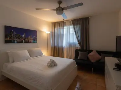 a bedroom with a white bed with a teddy bear on it at 713 Miami Beach Apartments in Miami Beach