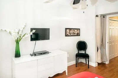 a living room with a tv on a white dresser at 713 Miami Beach Apartments in Miami Beach
