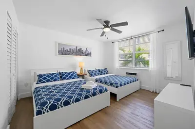 a bedroom with two beds and a ceiling fan at 713 Miami Beach Apartments in Miami Beach