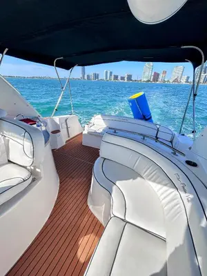 a boat on the water with a city in the background at Party On The Seas in Miami
