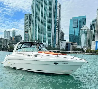 a white boat in the water in front of a city at Party On The Seas in Miami