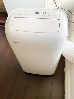 a white washing machine sitting on the floor at Lodgings by Lisa in Cooper City