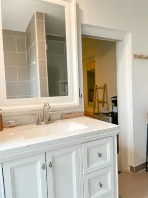 a bathroom with a sink and a mirror at Lodgings by Lisa in Cooper City