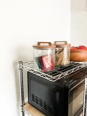 a rack on top of a microwave with food at Lodgings by Lisa in Cooper City