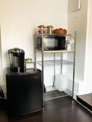 a kitchen with a black refrigerator and a microwave at Lodgings by Lisa in Cooper City