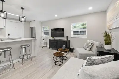 a living room with a couch and a kitchen at Perfect stay for 2-Walk to Wilton Drive-Shops &bars in Fort Lauderdale