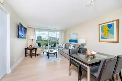 a living room with a couch and a table at Amazing Intracoastal Views - Walk to the Beach! in Fort Lauderdale