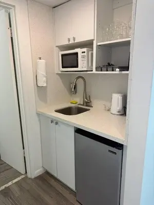 a kitchen with a sink and a microwave at 1701 - Studio Ocean Front Free Parking Pool in Miami Beach