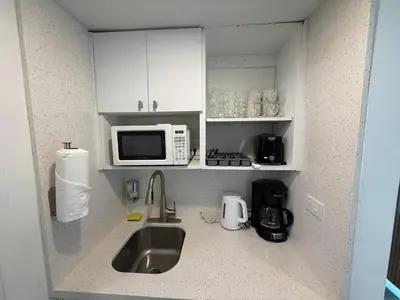 a kitchen with a sink and a microwave at 1701 - Studio Ocean Front Free Parking Pool in Miami Beach