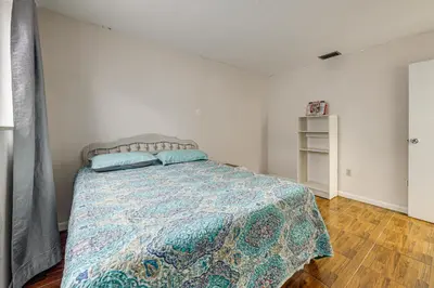 a bedroom with a bed with a quilt on it at Canal-Front Gem with Pool 3 Mi to Hard Rock Stadium in Miramar