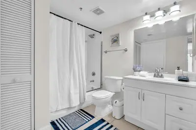 a white bathroom with a toilet and a sink at Lux condo on 25floor in Brickell in Miami