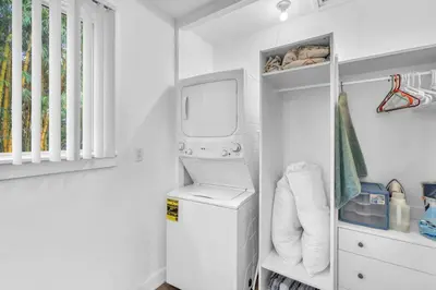 a white laundry room with a washer and dryer at Bromeliad Bungalow - Downtown Cottage in Fort Lauderdale