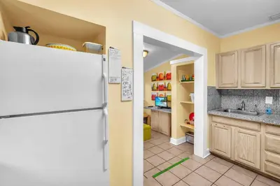 a kitchen with a white refrigerator in a room at Blue Reverie - Downtown Cottage in Fort Lauderdale