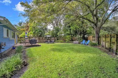 a yard with two chairs and a fence at Blue Reverie - Downtown Cottage in Fort Lauderdale