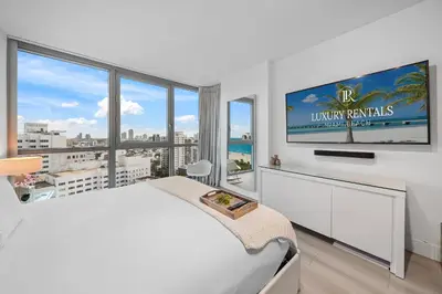 a bedroom with a large bed and a large window at Stunning Ocean View Private Residence at The Setai - 2002 in Miami Beach