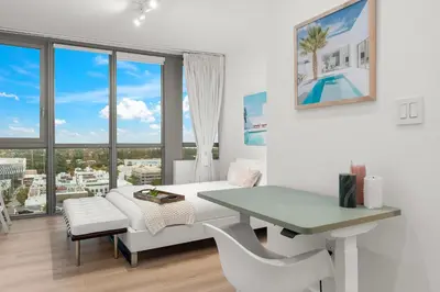 a white living room with a table and a couch at Stunning Ocean View Private Residence at The Setai - 2002 in Miami Beach