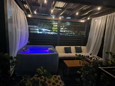 a jacuzzi tub in a room with a couch at Magic City IN THE HEART OF MIAMI in Miami