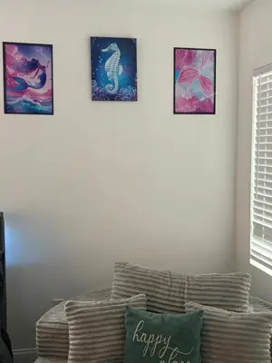 a living room with four pictures on the wall at Family Willy Michel in Opa-locka