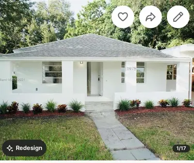a white house with the words revision and the house at Family Willy Michel in Opa-locka