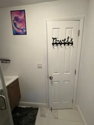 a room with a white door with a sign on it at Family Willy Michel in Opa-locka