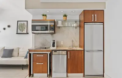 a kitchen with a refrigerator and a microwave at Spacious Studio Rooftop Pool & Bar with Ocean View in Miami Beach