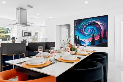 a dining room with a table with glasses of wine at Cozy 4BR Pool Villa Near The Beach with Arcades in Fort Lauderdale