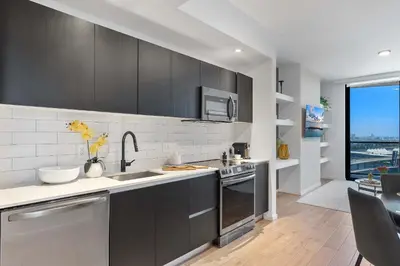 a kitchen with stainless steel appliances and a large window at MVR - 2BR Luxury Stay in the Heart of Miami in Miami