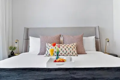 a white bed with a tray of fruit on it at MVR - 2BR Luxury Stay in the Heart of Miami in Miami