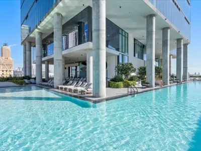 a swimming pool in front of a building at MVR - 2BR Luxury Stay in the Heart of Miami in Miami