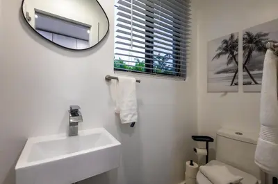 a white bathroom with a sink and a mirror at The Side Villa in Miami