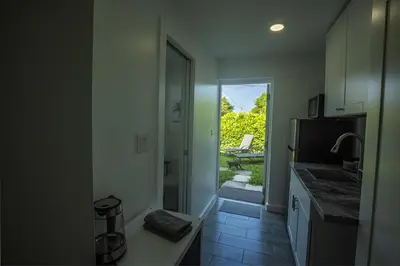 a kitchen with a sink and a door to a patio at The Side Villa in Miami