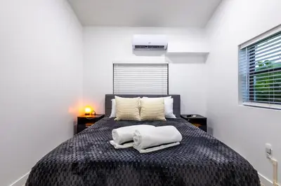 a bedroom with a bed with two towels on it at The Side Villa in Miami