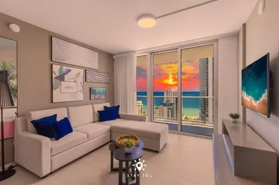 a living room with a couch and a view of the ocean at Luxury 2BR Apt With Ocean View Pool & Amenities in Hollywood