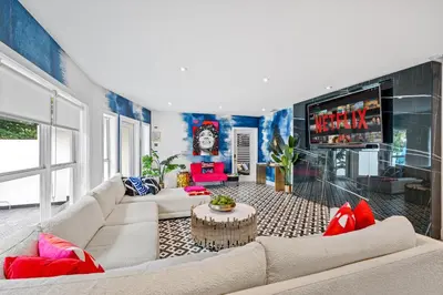 a living room with a couch and a table at Beach Pop - Steps to Beach Heated Pool & Hot Tub in Fort Lauderdale
