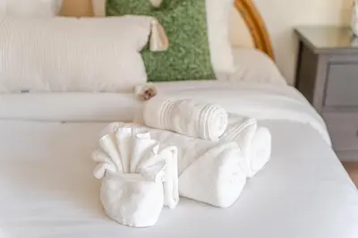 a white bed with towels on it at Oceanfront Bliss Cozy 1BR by Beach Free Parking in Hollywood