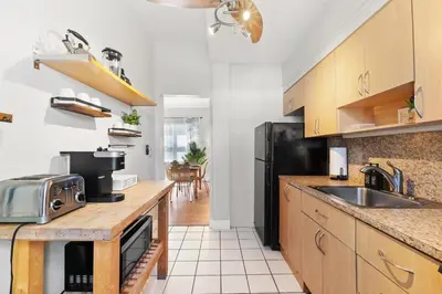 a kitchen with a sink and a black refrigerator at Oceanfront Bliss Cozy 1BR by Beach Free Parking in Hollywood