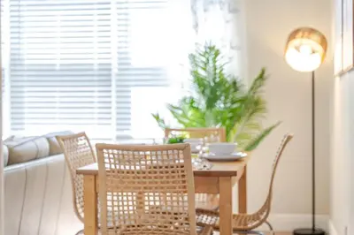 a dining room with a table with chairs and a lamp at Oceanfront Bliss Cozy 1BR by Beach Free Parking in Hollywood