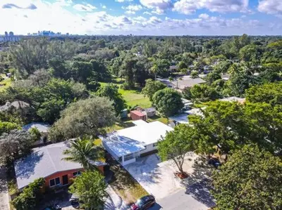 an aerial view of a house with a lot of trees at Miami Luxury Home Close to Beach & Aventura Mall in Biscayne Park