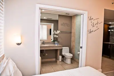 a bathroom with a sink and a toilet and a mirror at Cozy Studio Ocean Drive - Roof Top Pool with Bar in Miami Beach