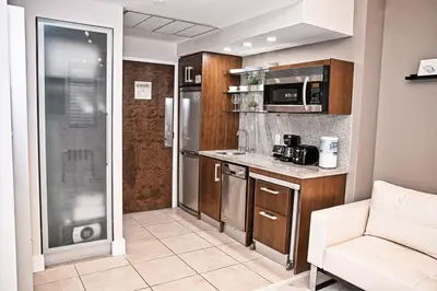 a small kitchen with a couch and a counter top at Cozy Studio Ocean Drive - Roof Top Pool with Bar in Miami Beach