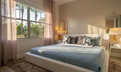 a bedroom with a bed and a large window at The iconic Ocean Drive - 1 BDR - Rooftop Pool and Bar in Miami Beach