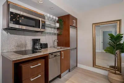 a kitchen with a sink and a microwave at The iconic Ocean Drive - 1 BDR - Rooftop Pool and Bar in Miami Beach