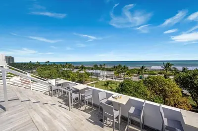 a balcony with chairs and a view of the ocean at Ocean Drive Retreat - Beach Access & Rooftop Pool in Miami Beach