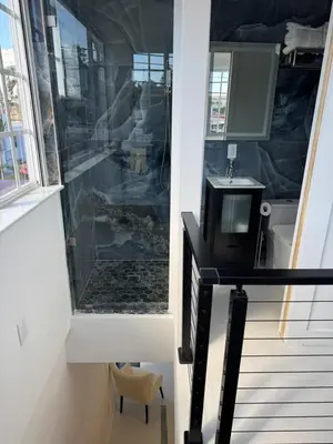 a room with a staircase with a tv on a table at In the heart of little Havana 5 in Miami