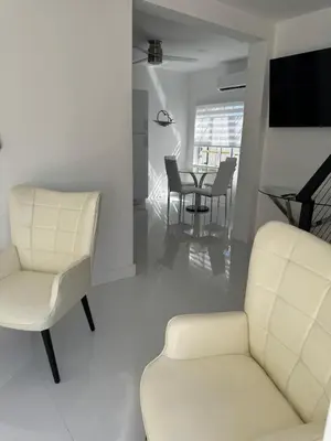 a living room with a chair and a table at In the heart of little Havana 5 in Miami