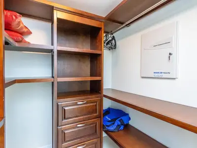 a walk in closet with wooden shelves at Lovely 2-Bedroom Oceanfront condo in Sunny Isles Beach